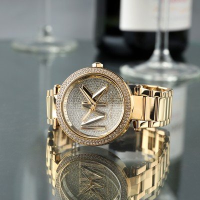 Michael Kors MK7283 Parker watch in gold with crystal accents on reflective surface