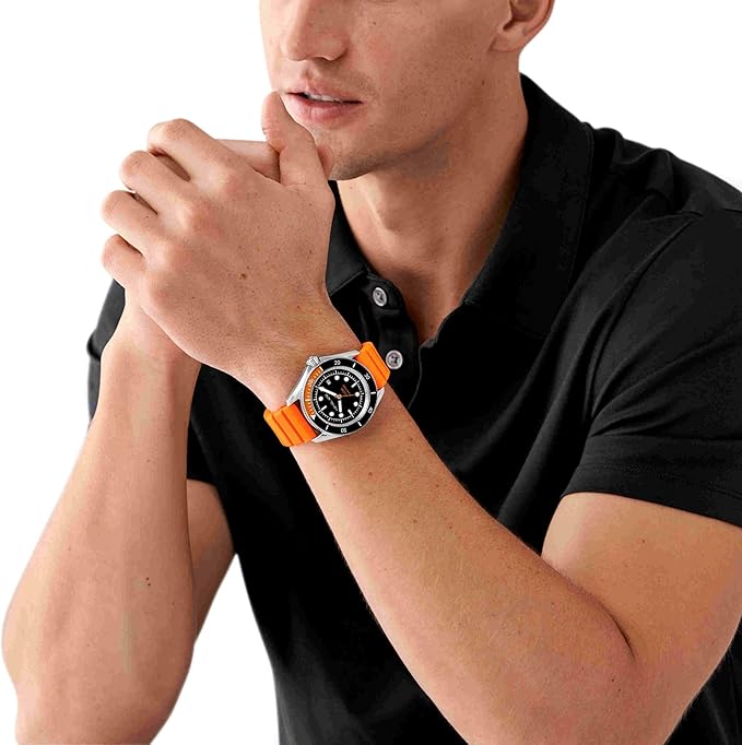 Michael Kors MK9157 watch worn on male wrist with black dial and orange rubber strap