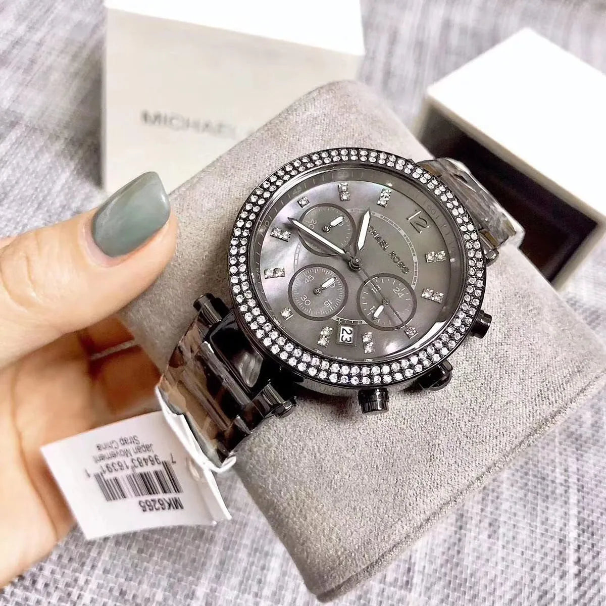 Michael Kors Parker MK6265 watch on wrist with grey steel strap and chronograph dial