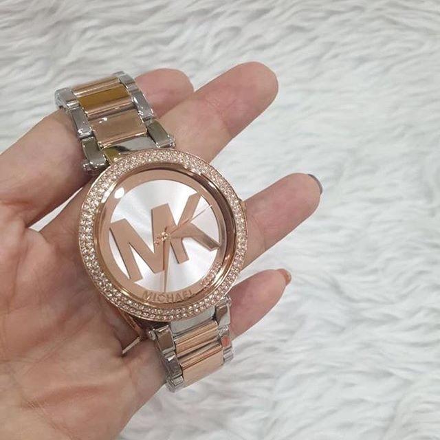 Michael Kors Parker MK6314 watch held in hand showing rose gold and silver bracelet details