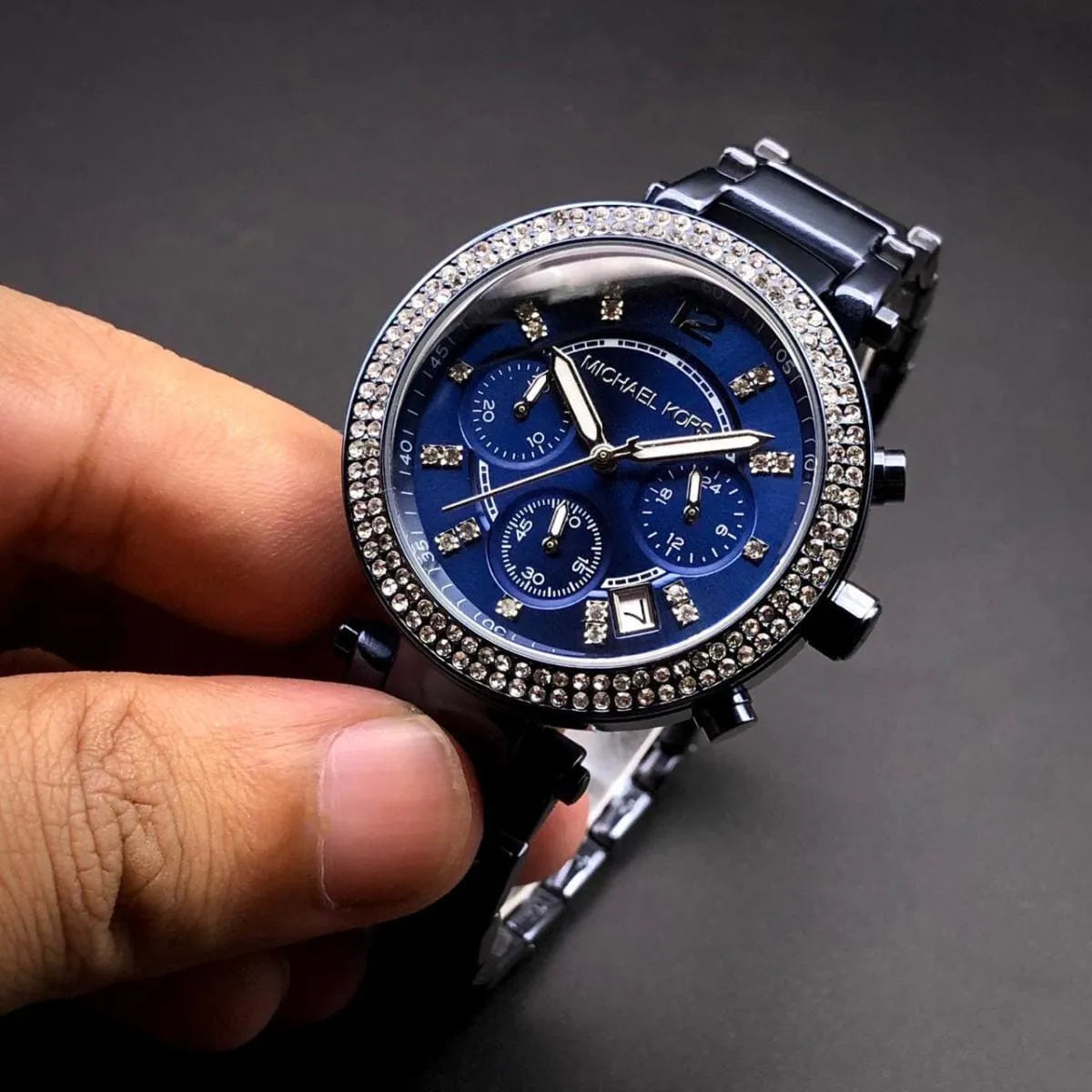 Michael Kors Parker MK6418 blue chronograph watch held in hand showing dial detail