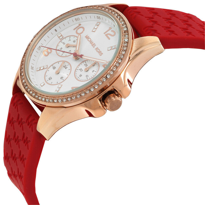 Michael Kors Pilot watch angle view showing rose gold case, diamond-set bezel, white dial, and red strap