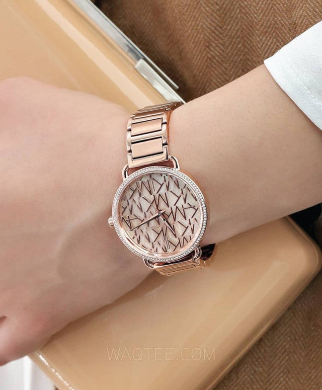 Michael Kors Portia mother-of-pearl watch on wrist with rose gold bracelet strap