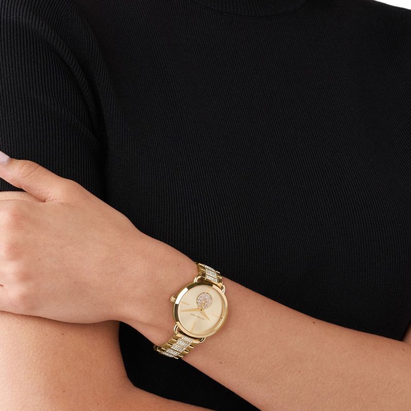 Michael Kors Portia gold-tone watch worn on wrist with crystal-embellished dial