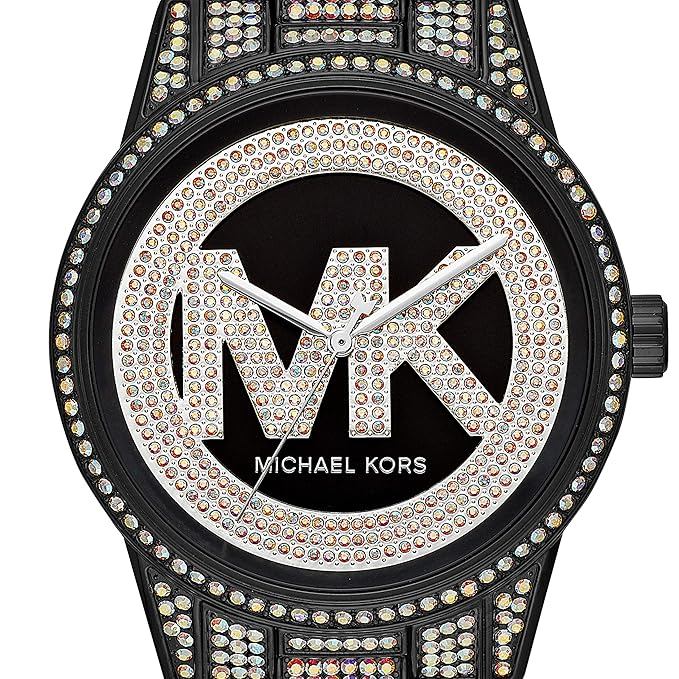 Close-up of pavé crystal dial with MK logo and bezel detail on black watch