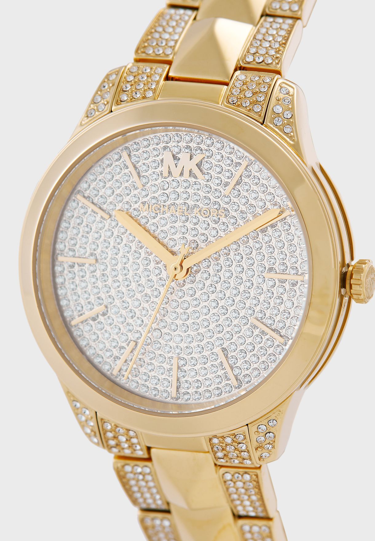 Michael Kors Runway Mercer watch dial detail showing crystal pave, gold hands and MK logo