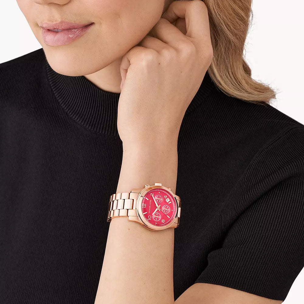 Michael Kors Runway rose gold women's chronograph watch MK7352 worn on wrist with pink chronograph dial