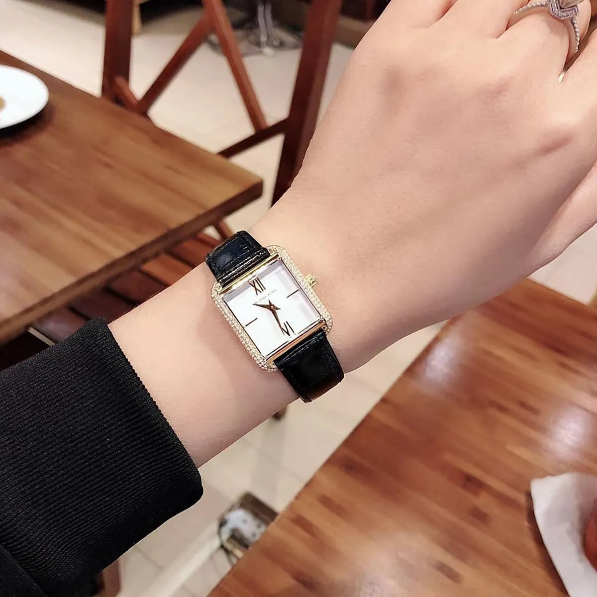 Michael Kors Lake MK2762 watch worn on wrist showing square white dial and gold bezel details