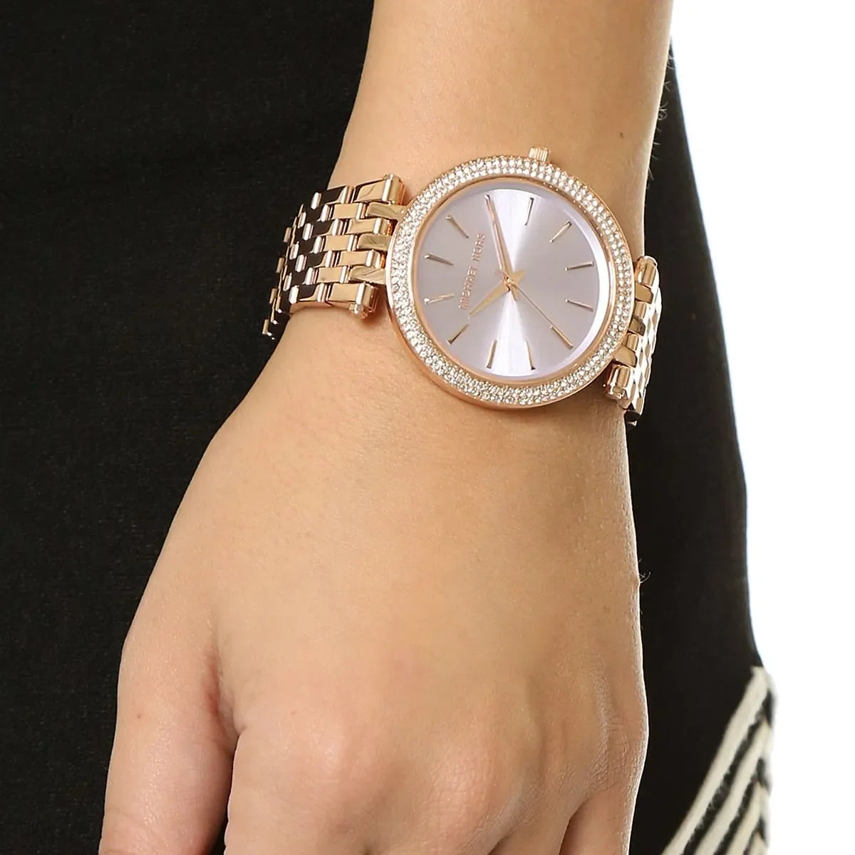 Michael Kors Darci women's watch on wrist showing rose gold case and rose gold steel strap