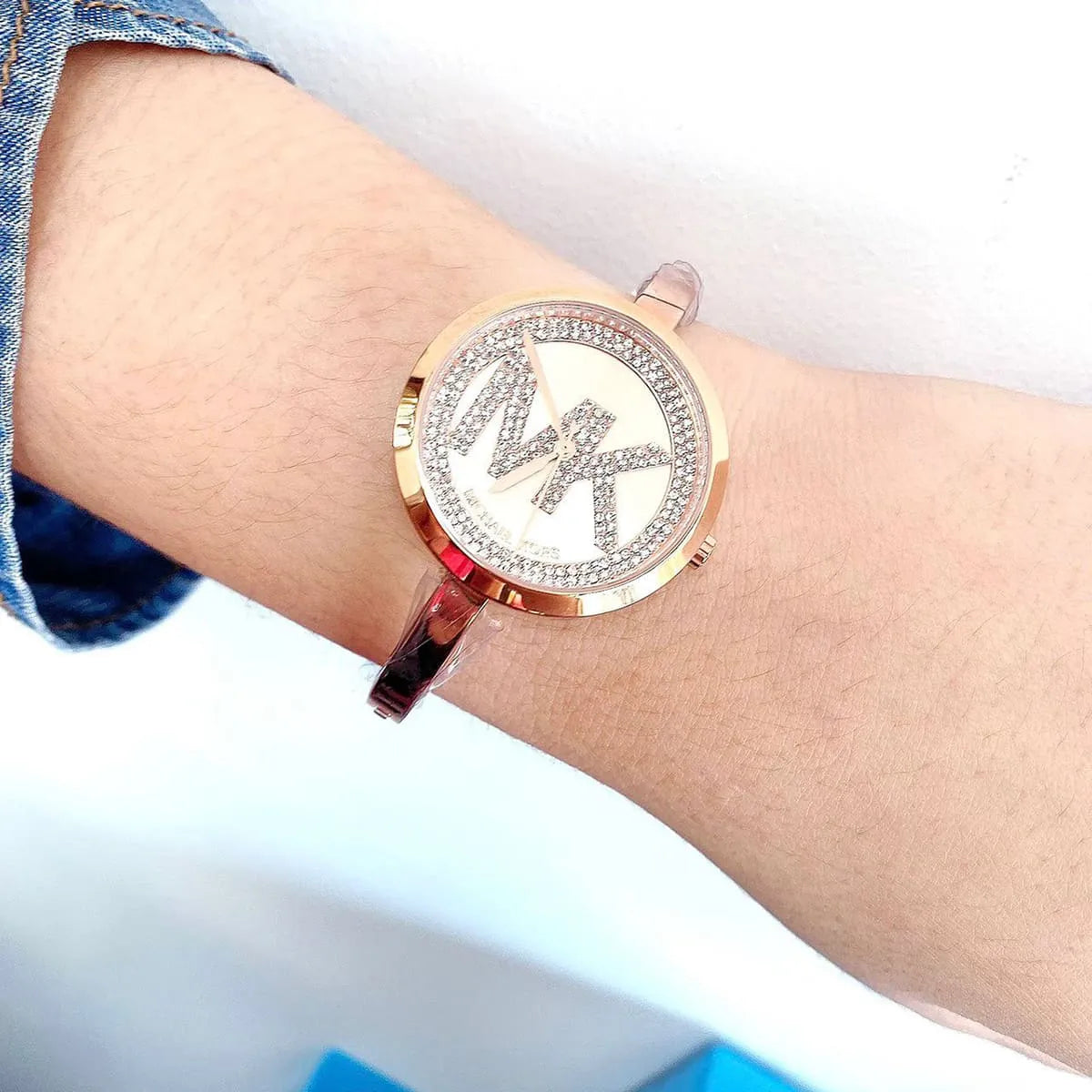 Michael Kors Blakley watch worn on wrist displaying rose gold tone and crystal design