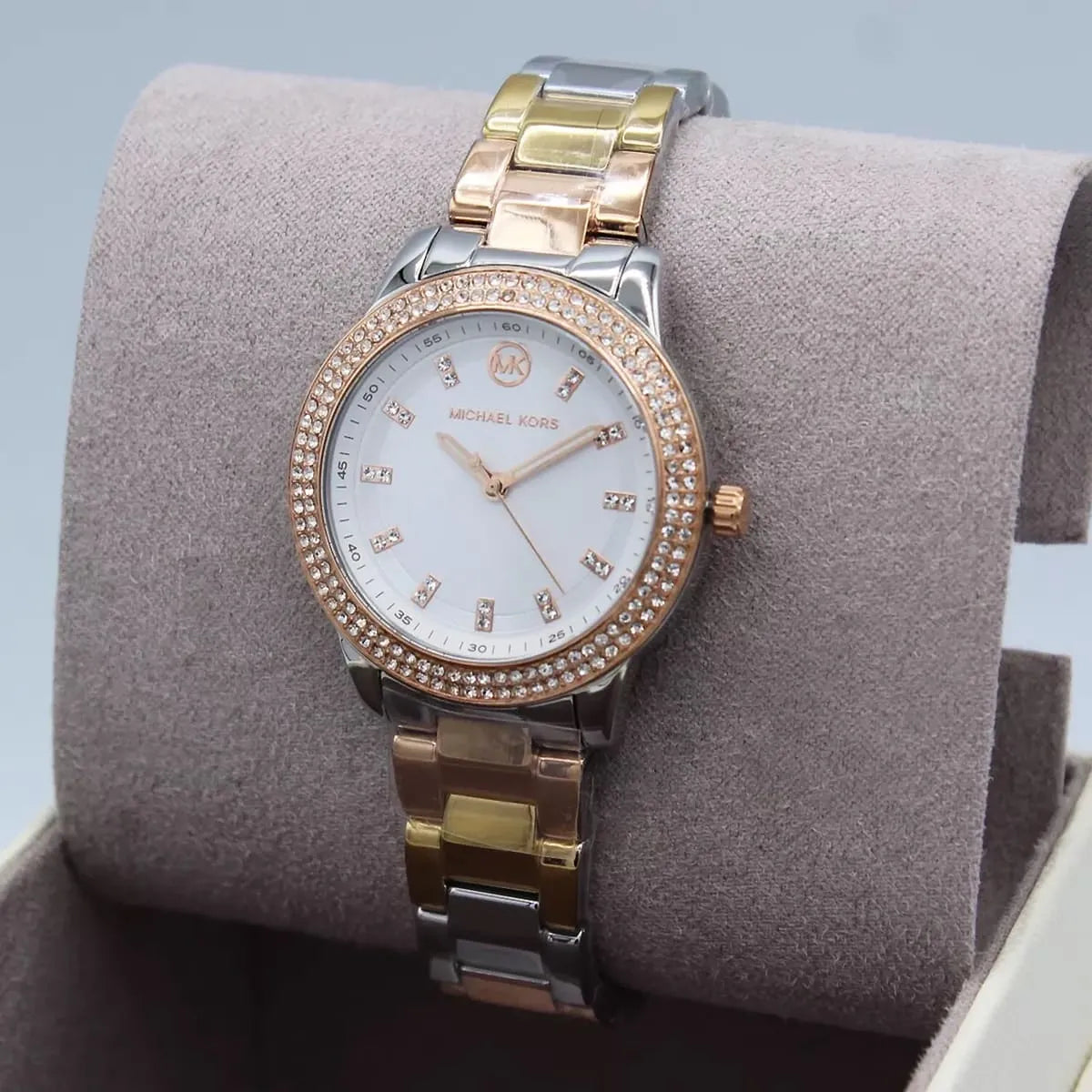 Michael Kors Camille MK4576 worn on wrist on beige fabric background