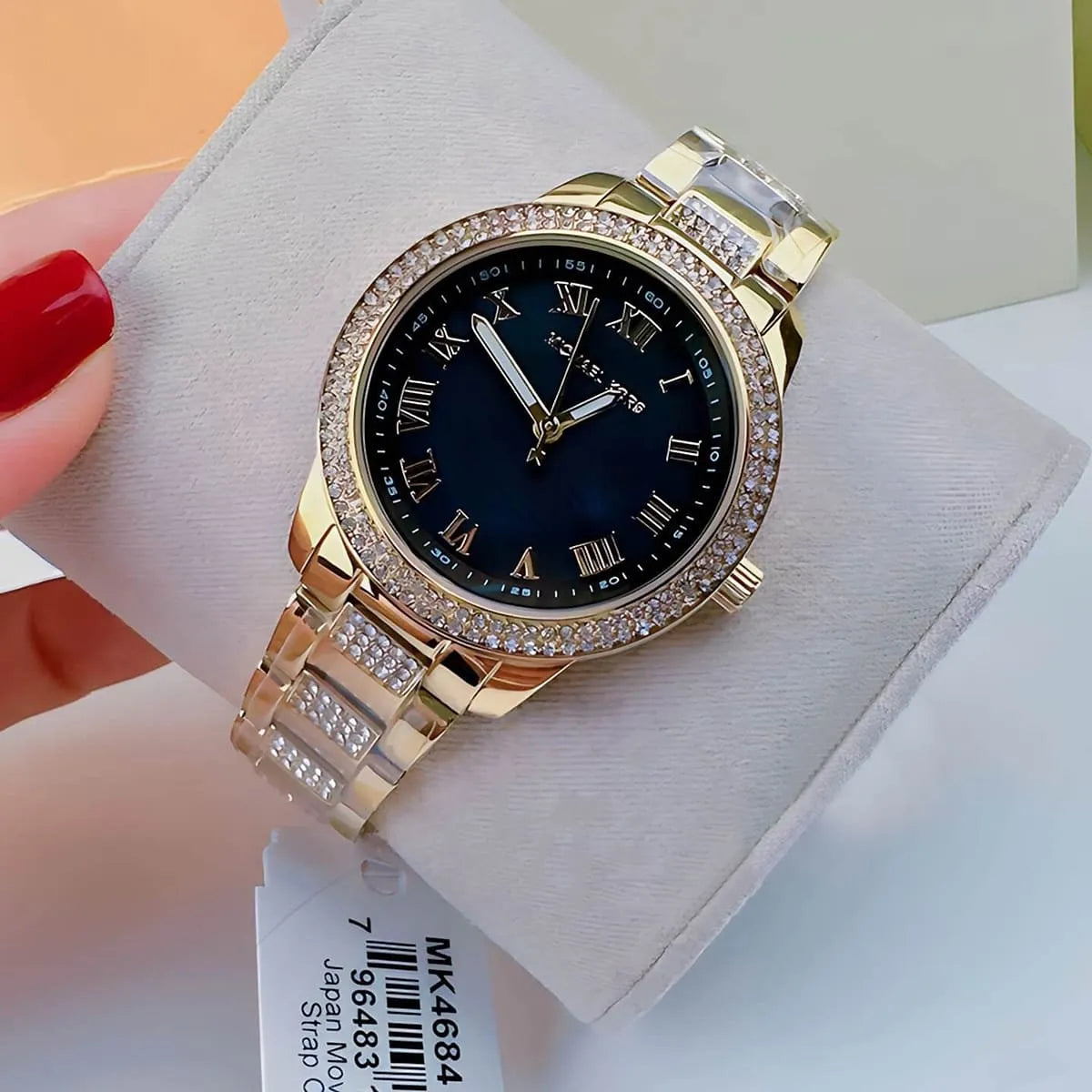 Michael Kors Tibby watch on wrist showing black dial with Roman numerals and crystal details