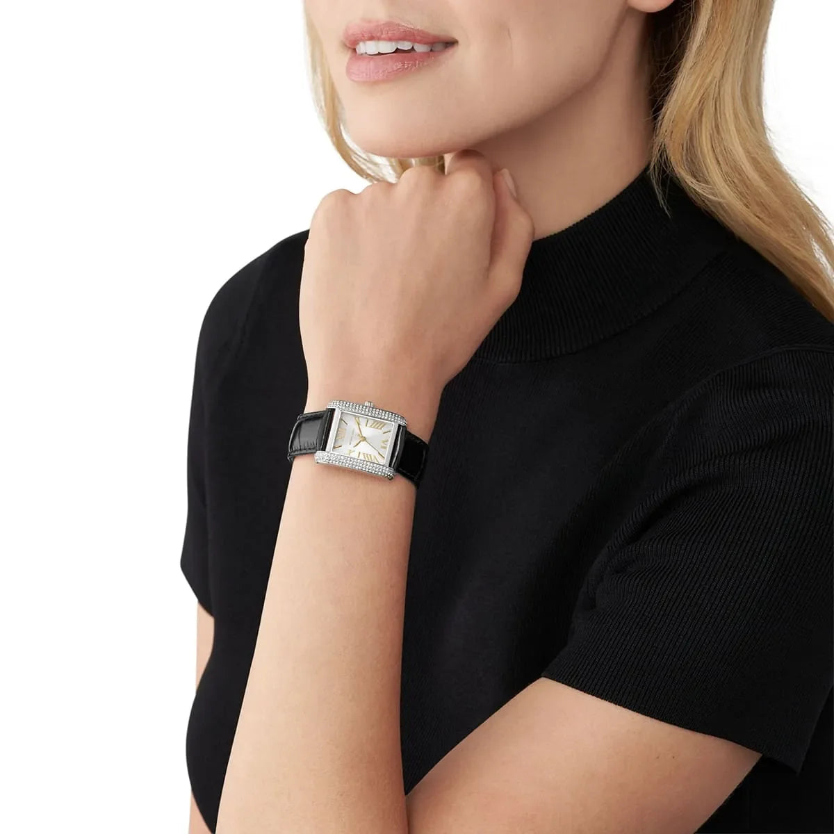 Michael Kors Emery watch worn on woman's wrist, showing the square pavé case and black strap