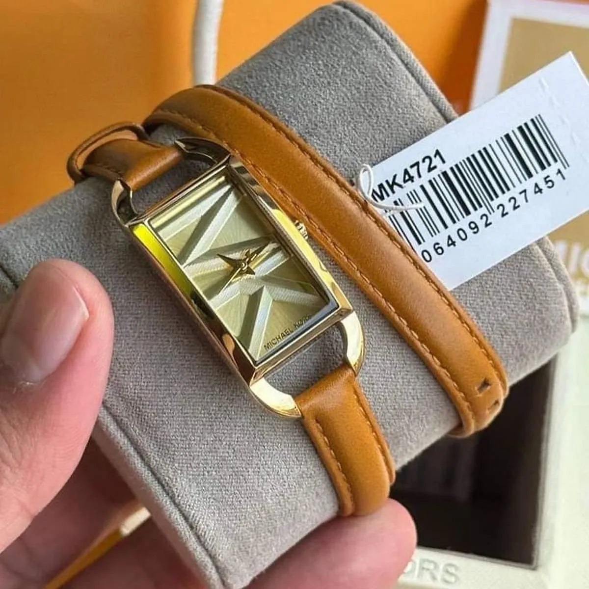 Michael Kors Empire watch with MK4721 label on gray fabric background