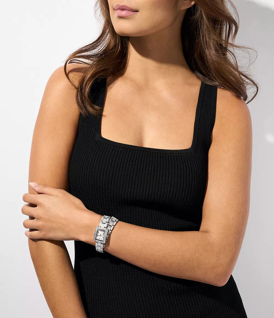 Michael Kors Petite Emery Pavé silver-tone watch worn on wrist with double wrap bracelet
