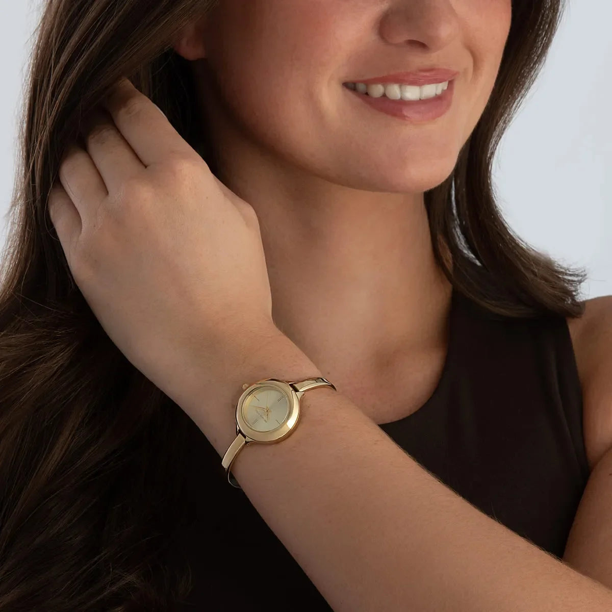 Michael Kors Izzy watch worn on woman's wrist showing gold dial and slim bracelet fit