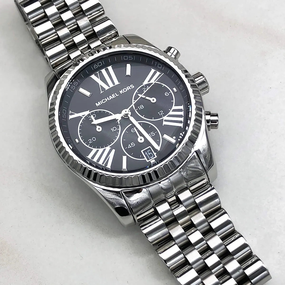 Michael Kors MK5708 chronograph watch on wrist with silver metal bracelet