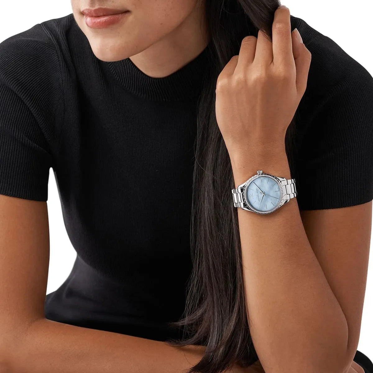 Michael Kors Layton watch worn on wrist showing blue dial and silver bracelet