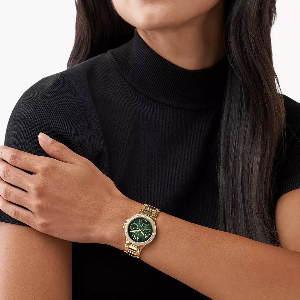 Michael Kors Camille Mini green dial gold watch worn on woman's wrist