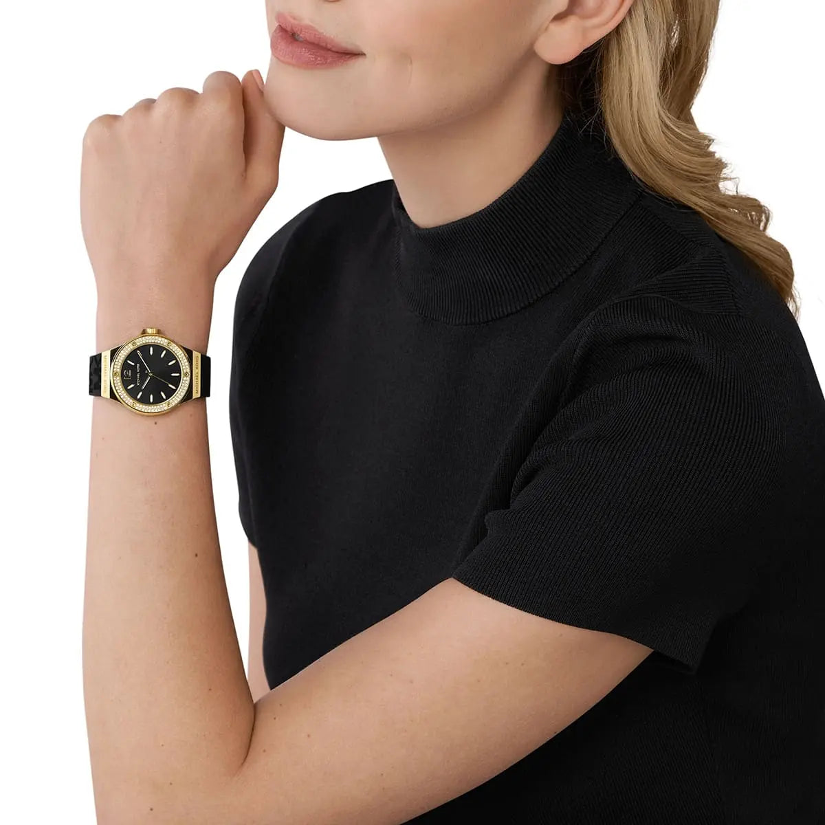 Michael Kors Lennox women's watch worn on wrist showing black dial and logo silicone strap