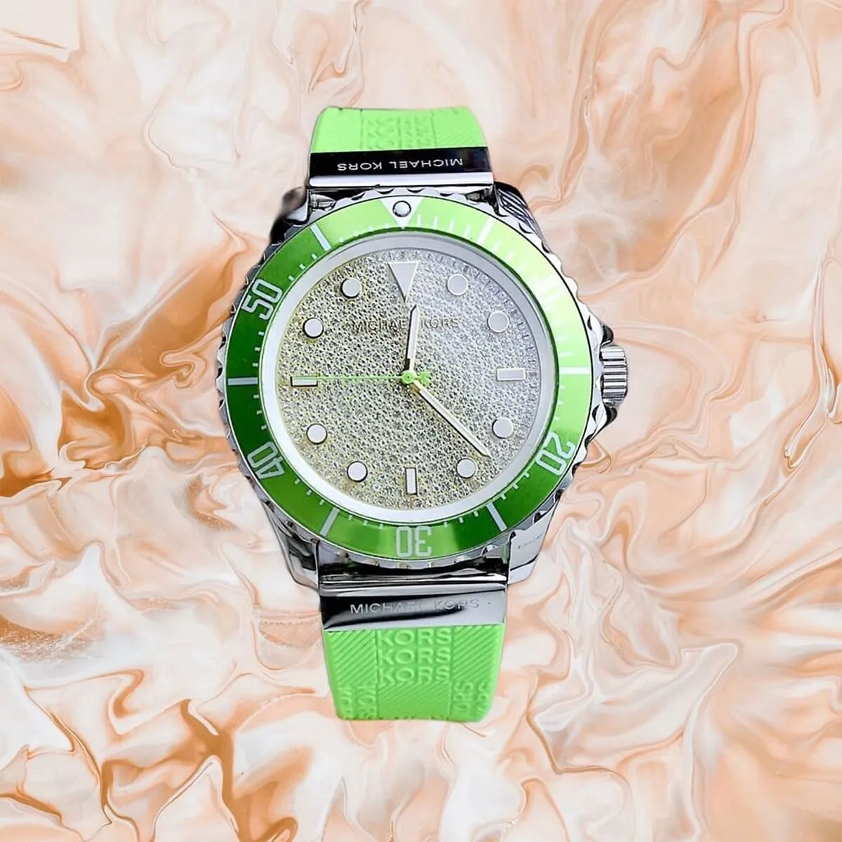 Michael Kors Everest watch worn on wrist with green bezel, crystal dial and green silicone strap