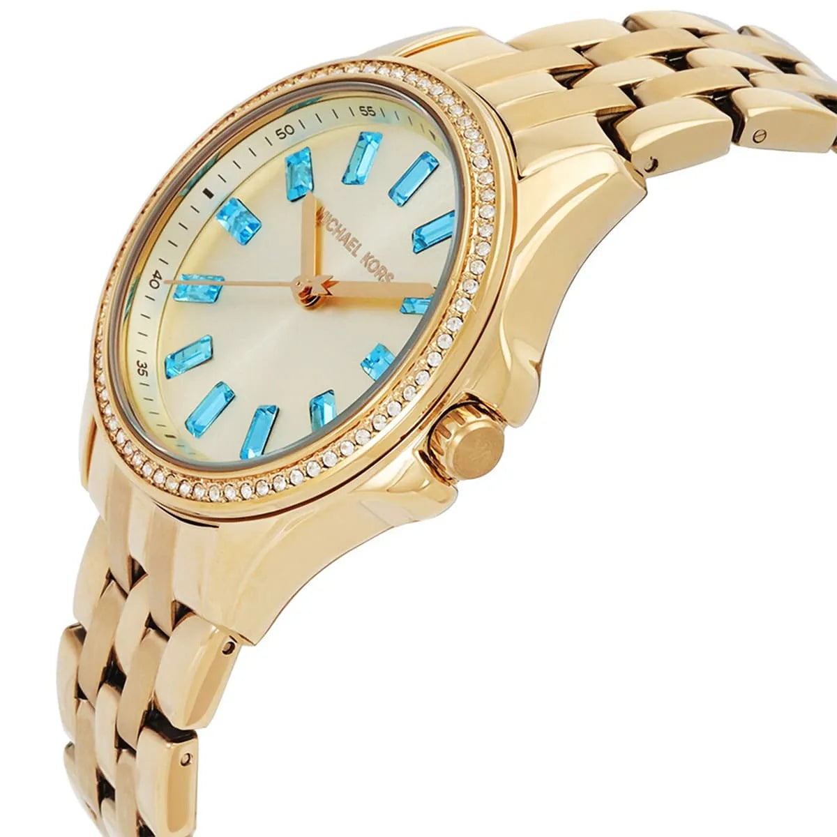 Michael Kors Mini Pilot watch at angle showing gold bracelet and turquoise markers