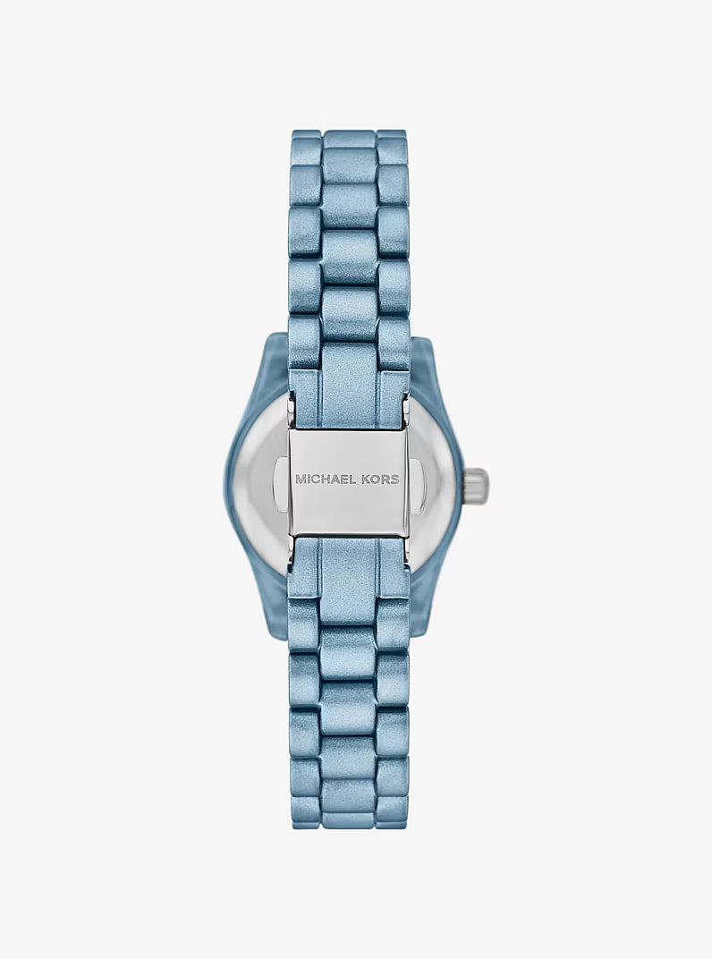 Michael Kors Lexington watch caseback showing blue stainless steel bracelet and engraved case
