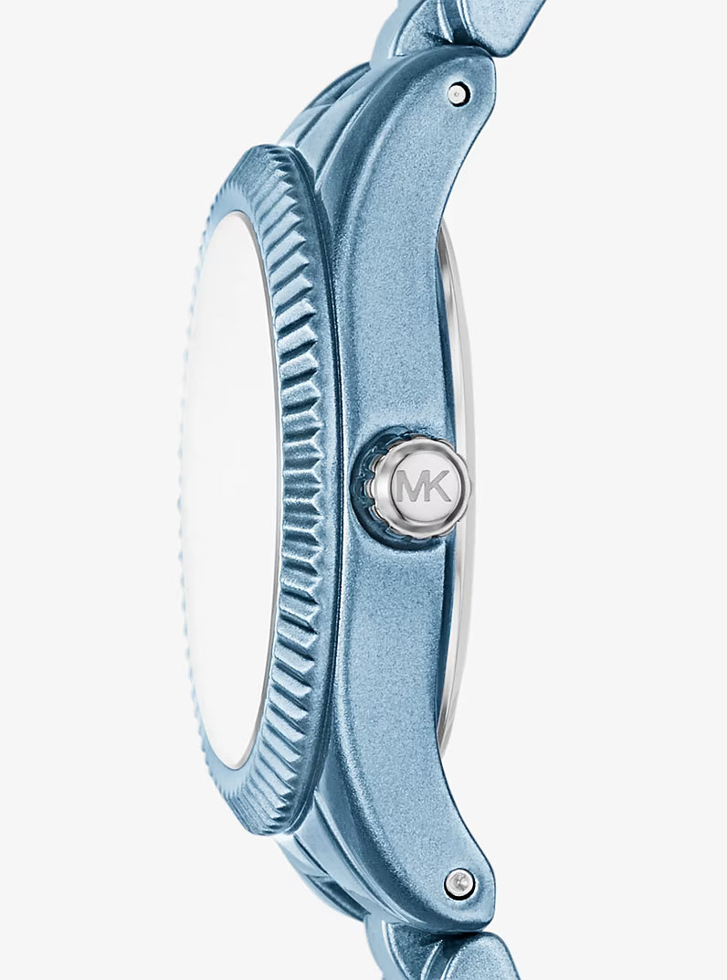 Side view of Michael Kors Lexington watch showing blue case profile and MK logo crown