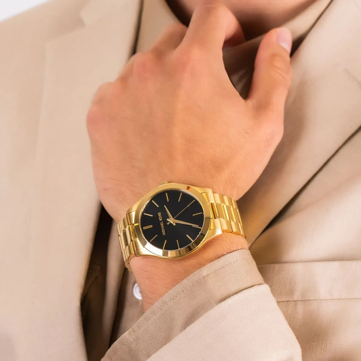 Michael Kors Runway MK8621 watch worn on wrist showing gold case and black dial