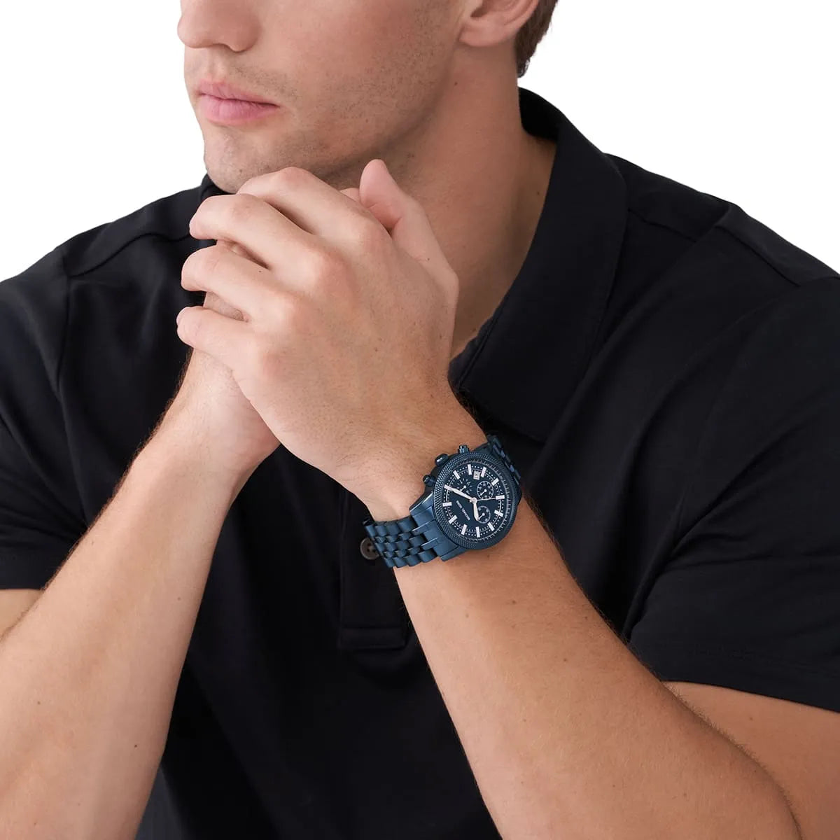 Michael Kors Hutton chronograph watch on wrist showing navy dial and metal bracelet