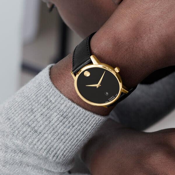 Movado Museum watch worn on wrist showing black dial and black leather strap