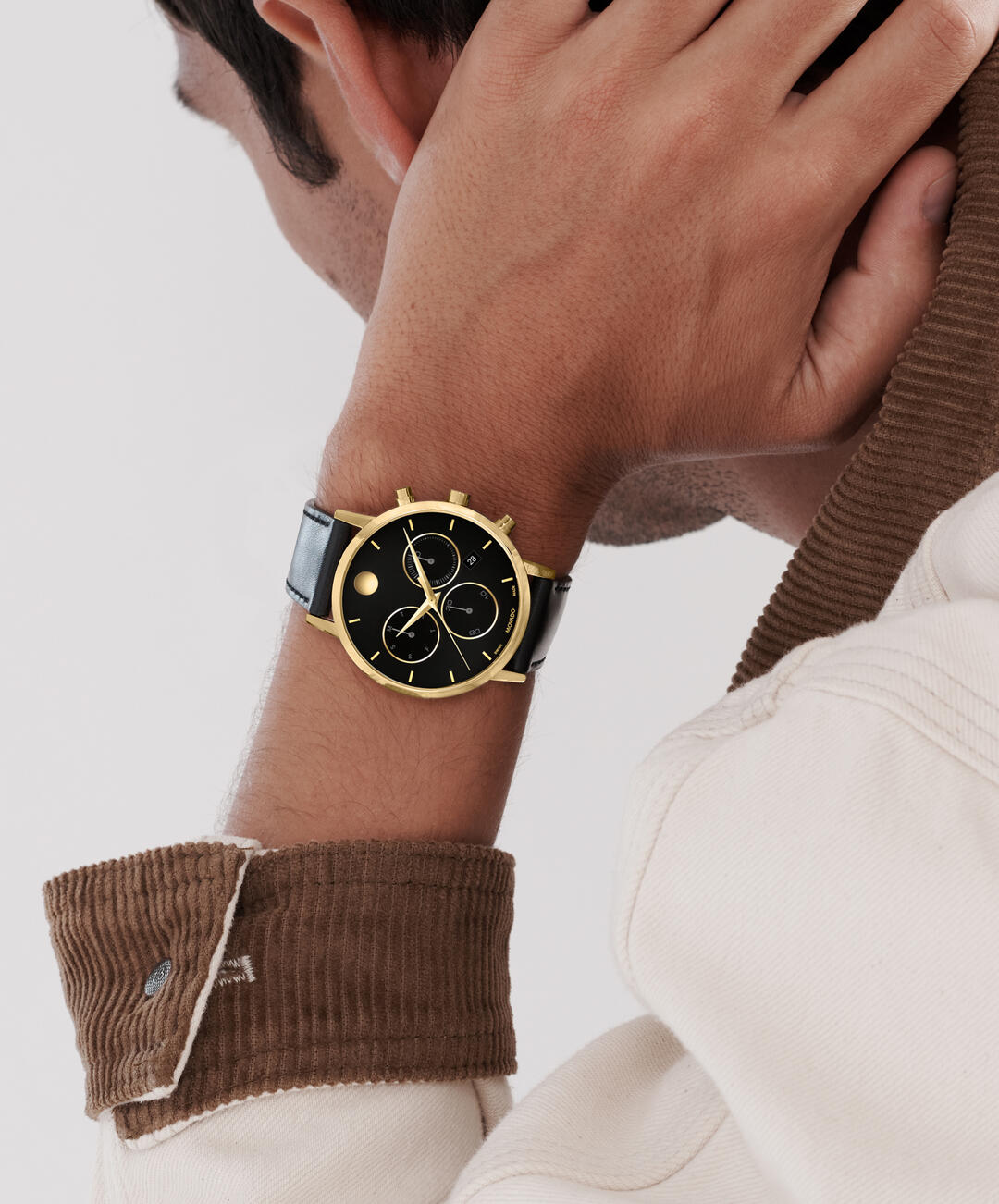Movado Museum Classic chronograph watch on wrist with black dial and gold-tone case