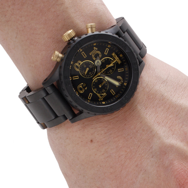 Nixon 42-20 Chrono worn on wrist displaying black dial and gold chronograph subdials
