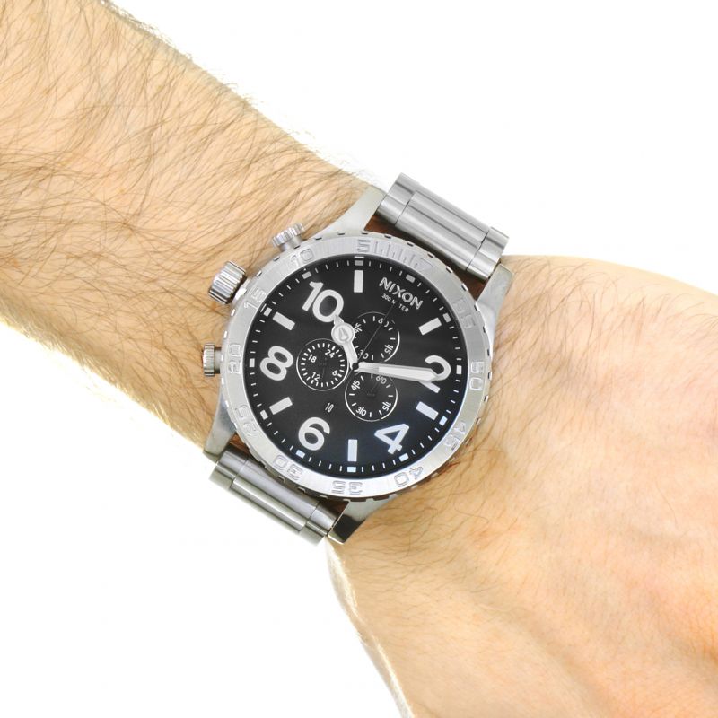 Nixon 51-30 chronograph watch worn on wrist showing black dial and steel bracelet