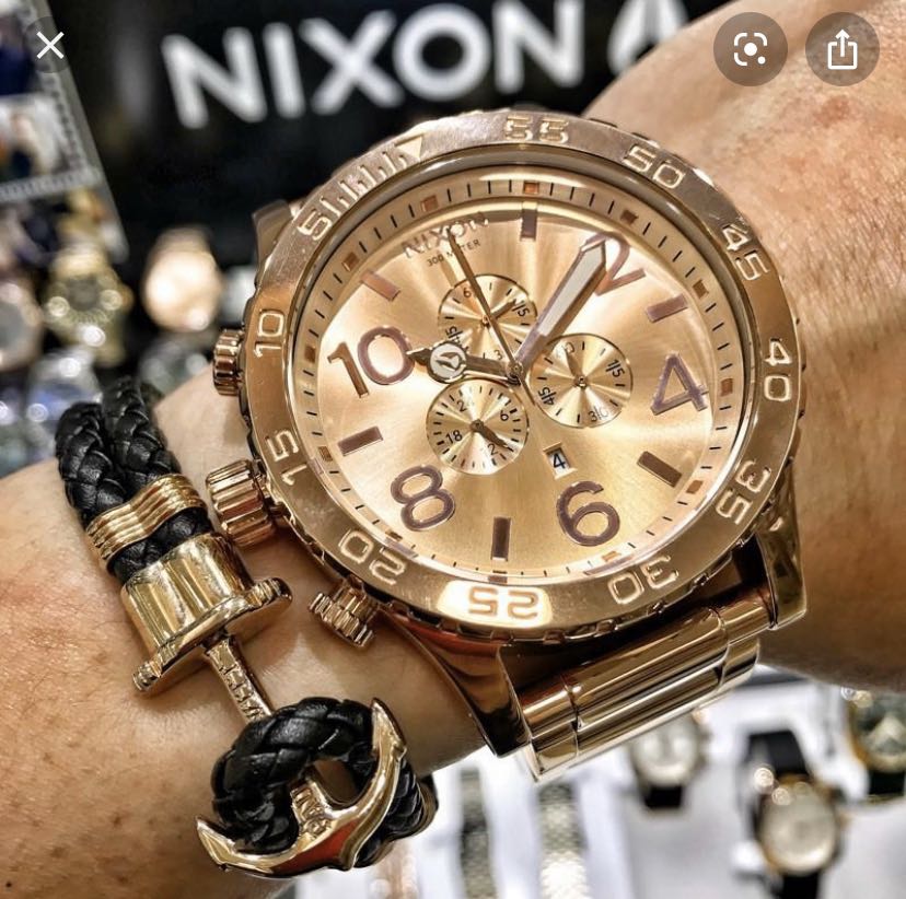 Nixon 51-30 Chrono rose gold chronograph worn on wrist with accessories