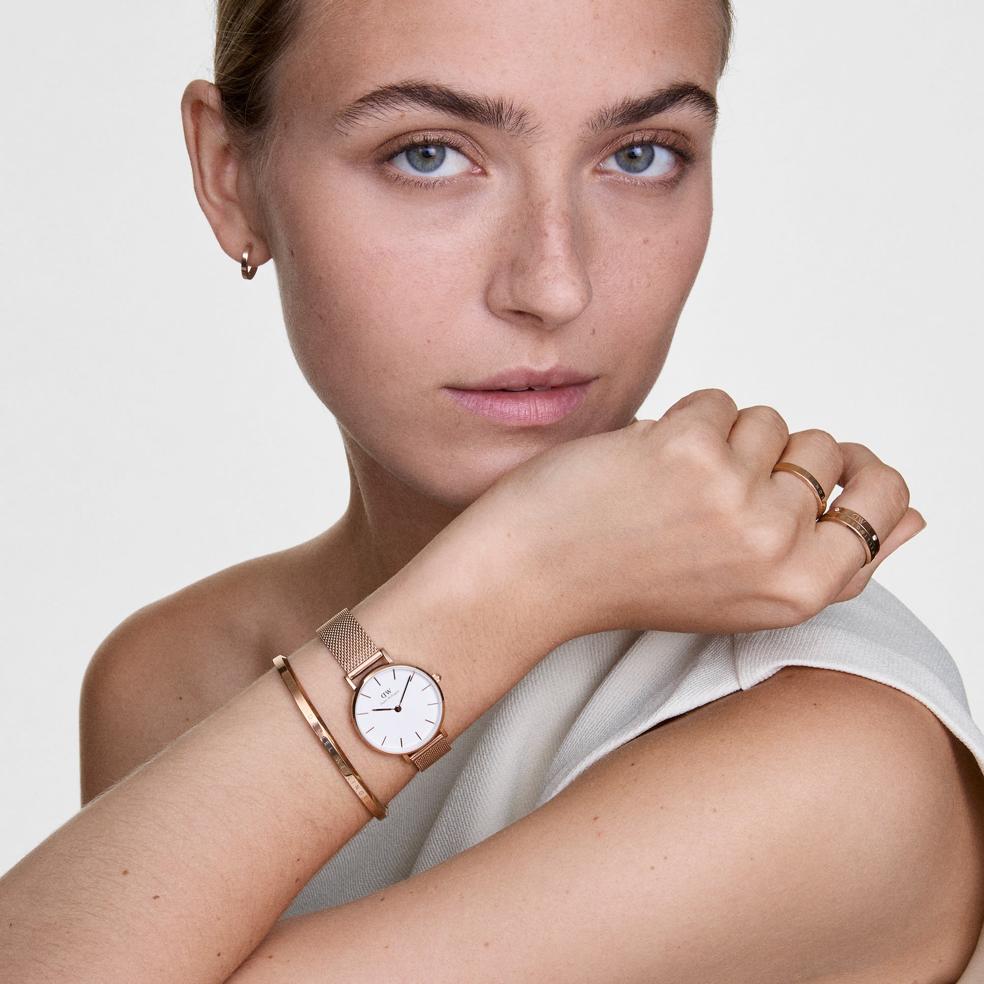 Quadro Pressed Melrose rose gold ring worn on wrist with watch and bracelets