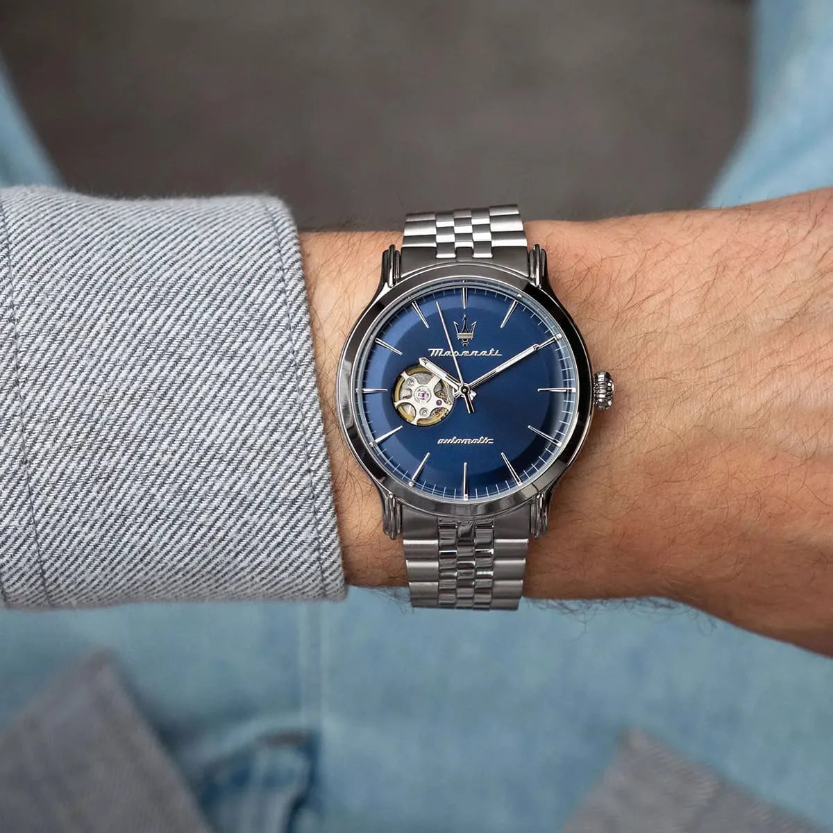 Maserati Epoca watch on wrist displaying blue dial with skeleton window and applied indices
