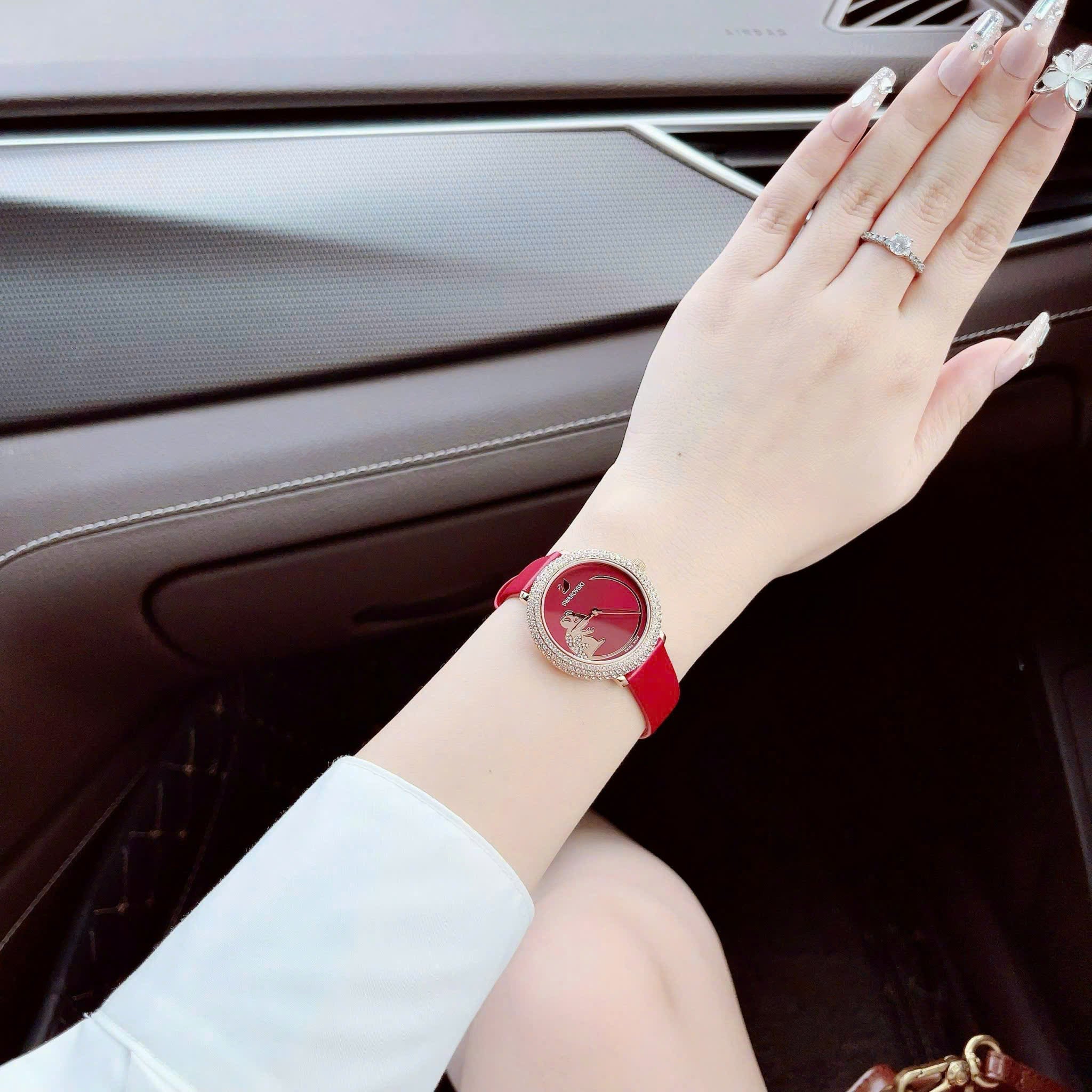 Crystal Frost watch on woman's wrist in car showing red leather strap and crystal bezel