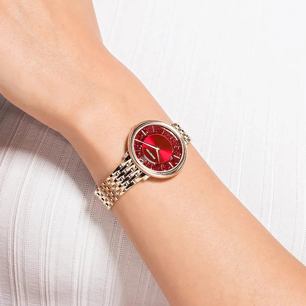 Crystalline Chic watch worn on wrist showing red dial and rose gold-tone bracelet fit