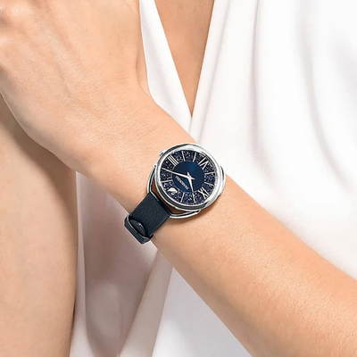 Swarovski Crystalline Glam watch worn on wrist with blue crystalline dial