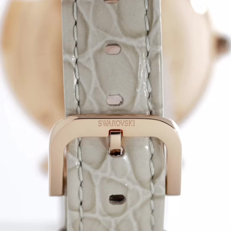 Close-up of Swarovski Crystalline Wonder beige leather strap with rose gold buckle detail