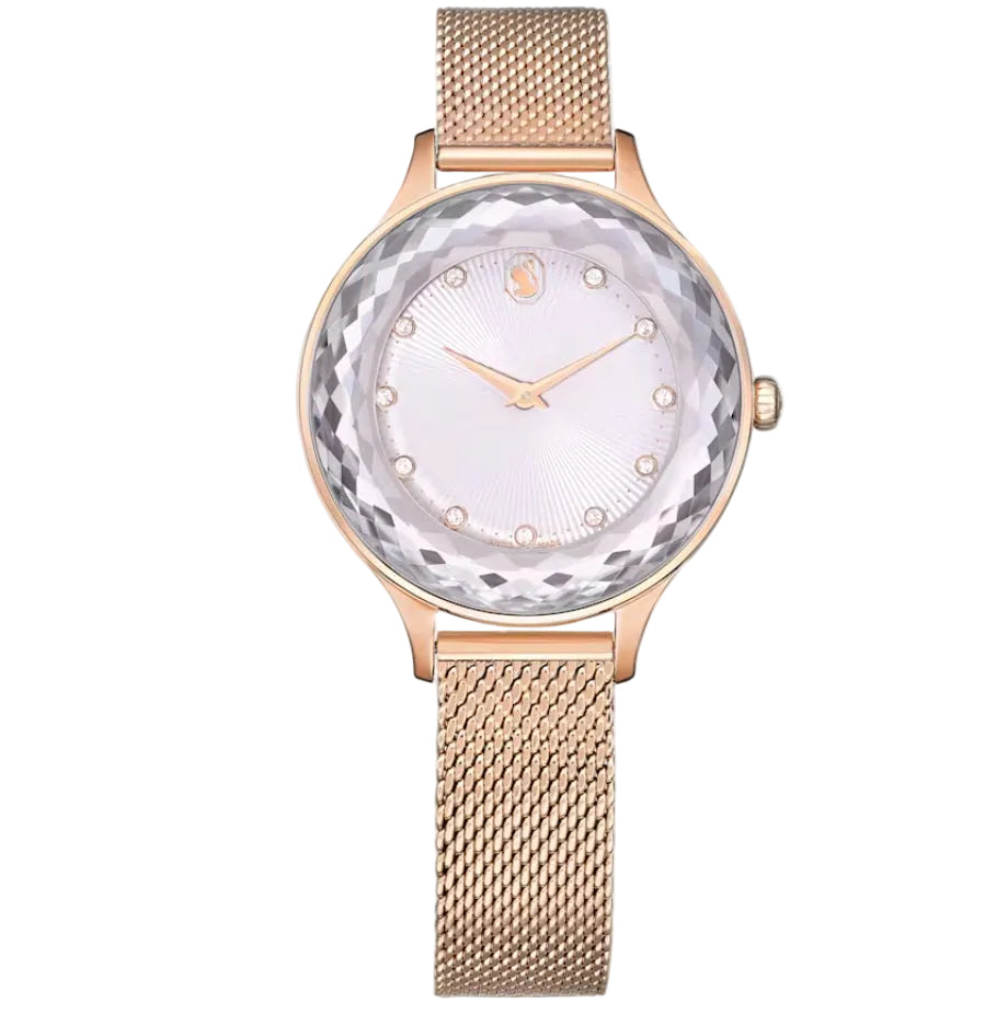 Swarovski Dextera watch front with crystal pave bezel, white dial, rose gold hands, and rose gold mesh strap