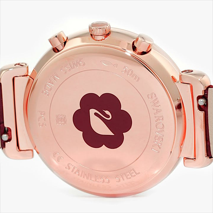 Champagne gold-tone caseback with engraved Swarovski logo and text, stainless steel construction