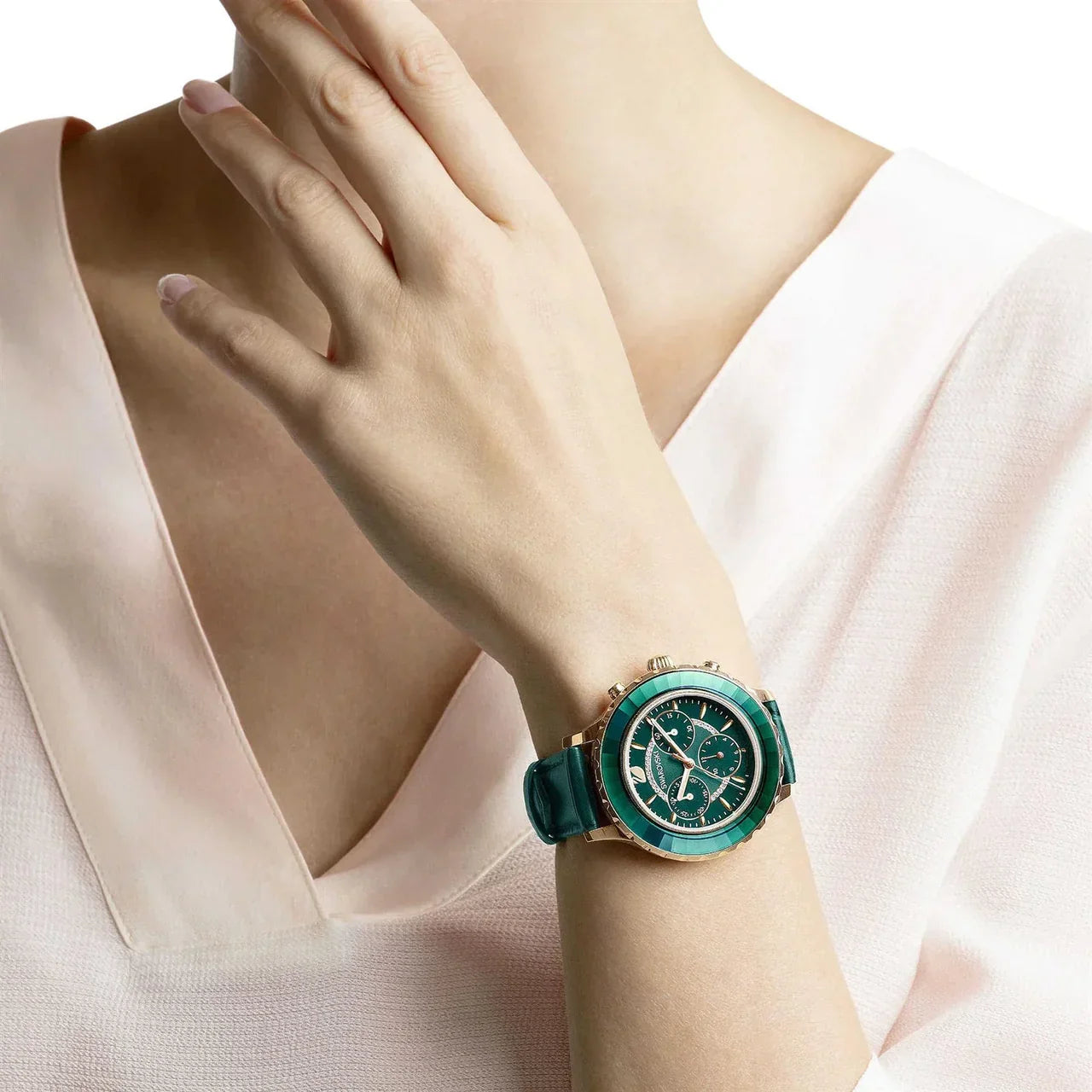 Swarovski Octea Lux Chrono green watch worn on wrist with green leather strap and turquoise bezel