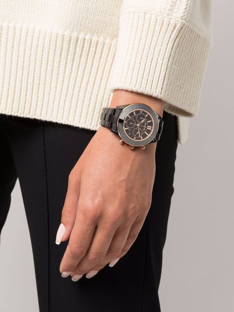 Octea Lux Sport chronograph watch worn on wrist with black dial and metal bracelet