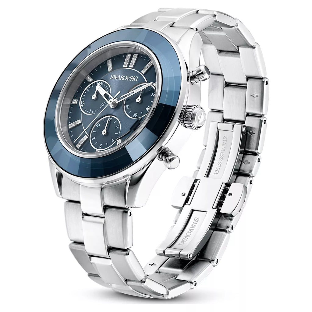 Swarovski Octea Lux Sport watch angled view showing blue bezel, silver steel bracelet, and chronograph subdials