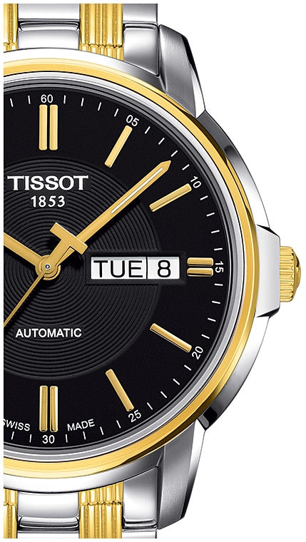 Tissot Automatics watch angle view showing black dial, gold indices, two-tone bezel and bracelet