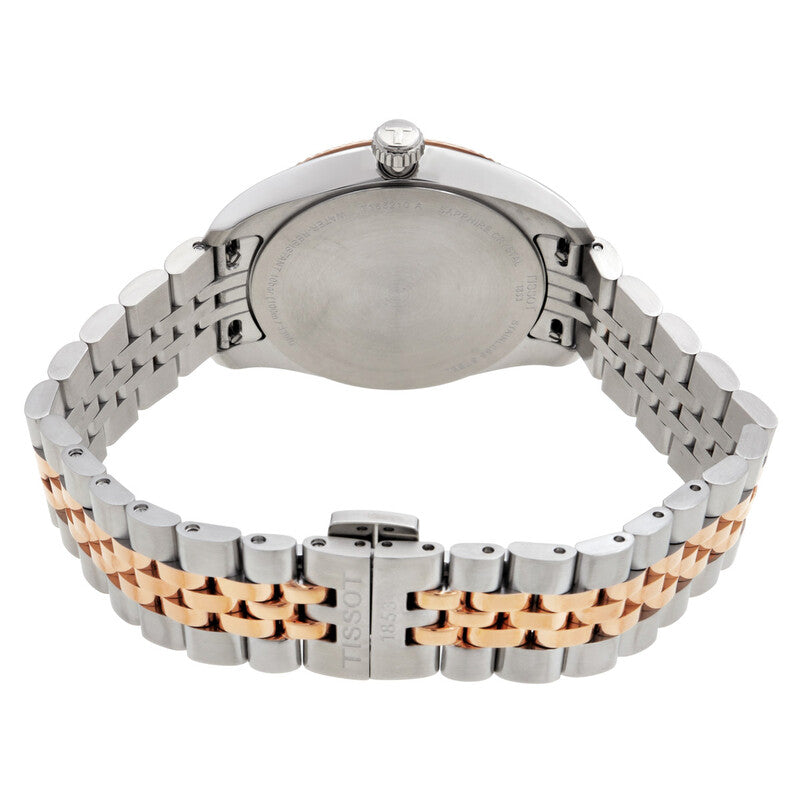Caseback view of Tissot Ballade watch showing two-tone bracelet, crown, and folding clasp