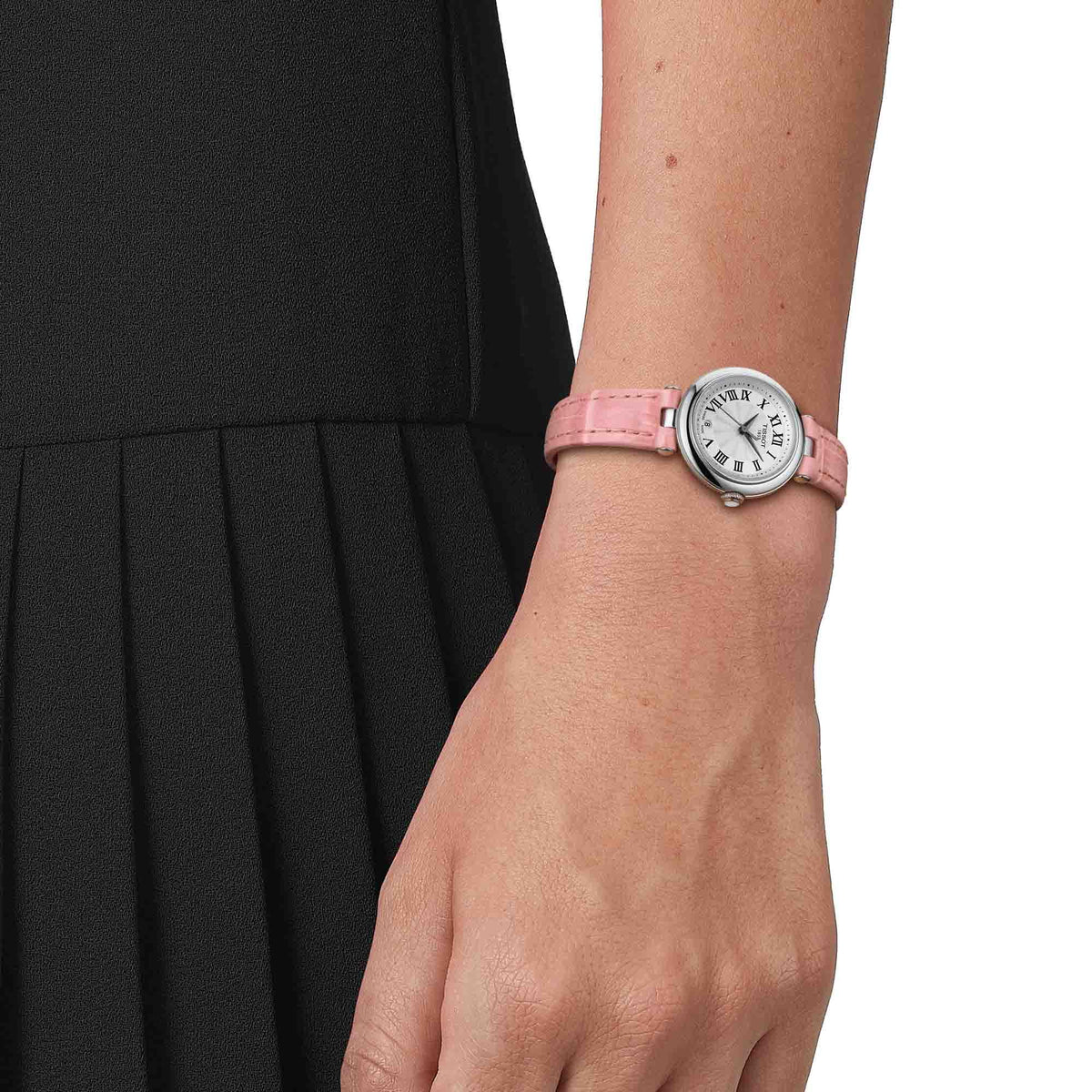 Tissot Bellissima ladies watch worn on wrist with pink leather strap against black sleeve