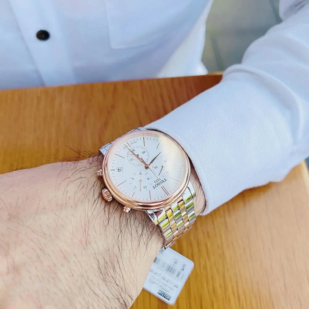 Tissot Carson Premium Chronograph worn on wrist with white dial and two-tone bracelet